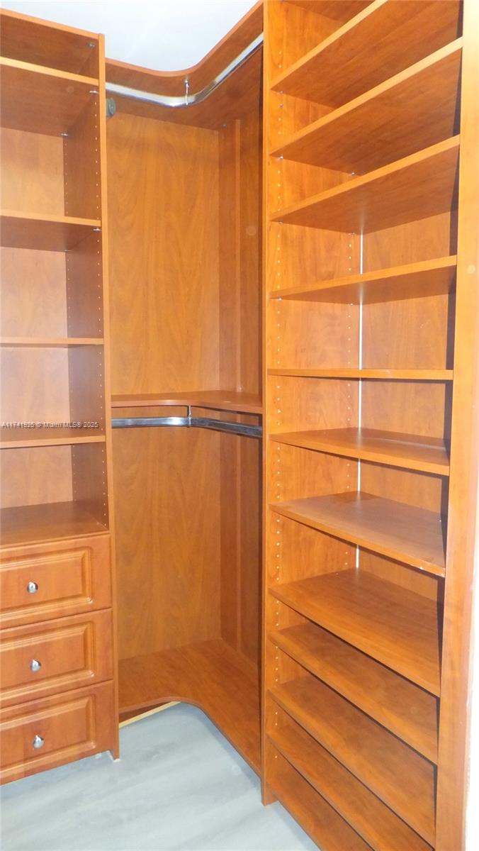 2775 Northeast 187th Street, Unit 329 Aventura, FL 33180 - Photo 7 of 21 a view of walk in closet with empty racks