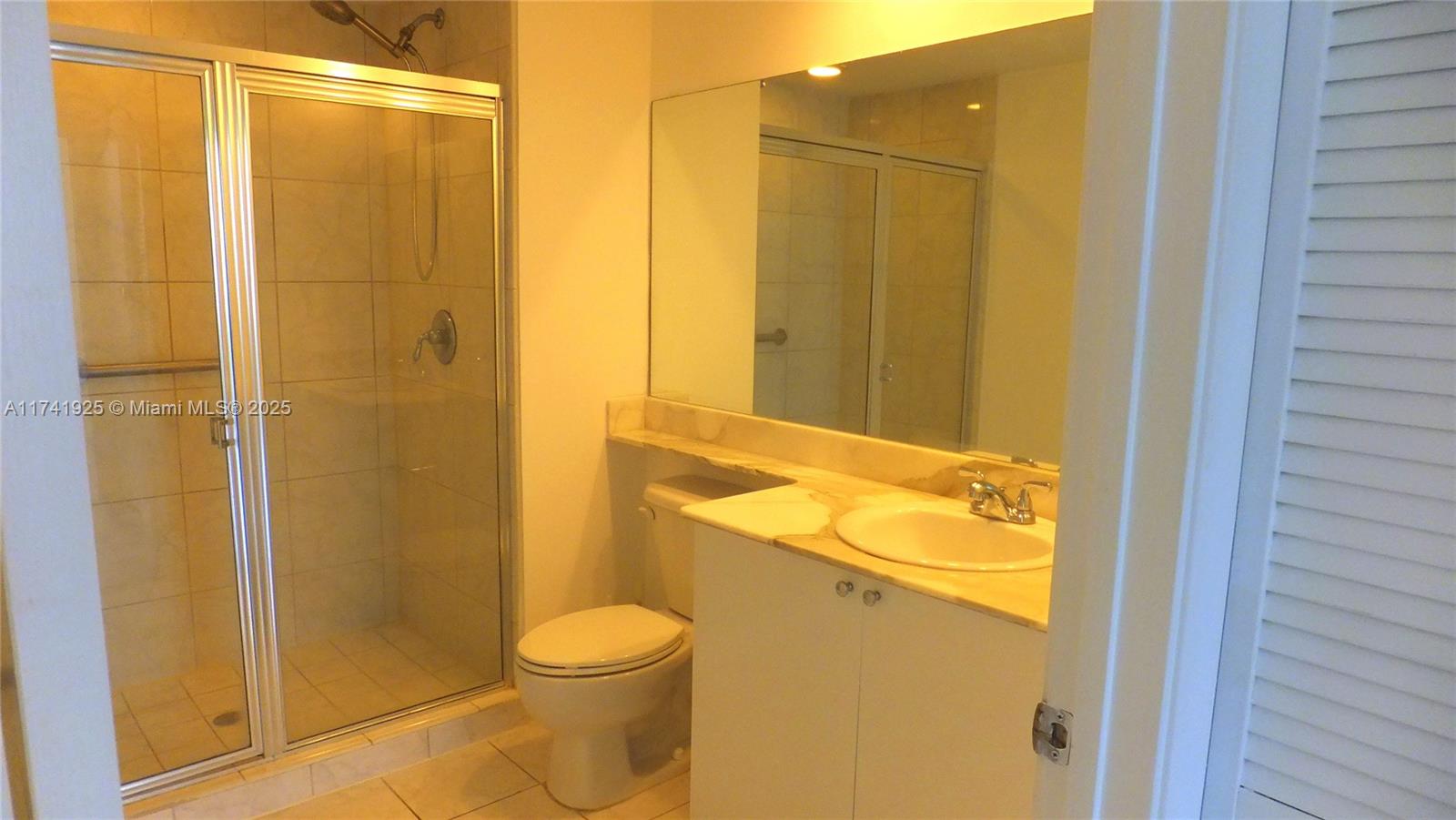 2775 Northeast 187th Street, Unit 329 Aventura, FL 33180 - Photo 9 of 21 a bathroom with a shower and a toilet