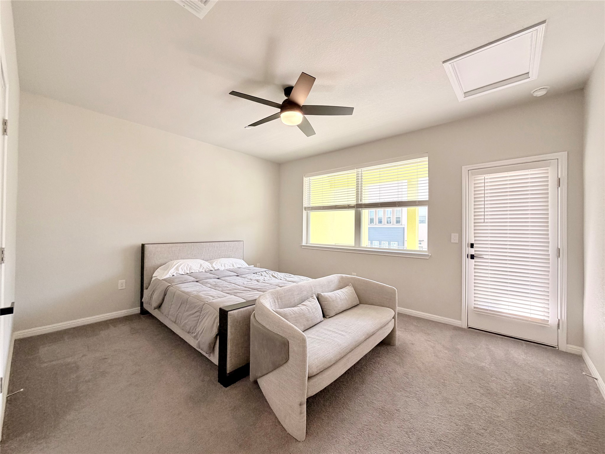 9015 Cattle Baron Path, Unit 1803 Austin, TX 78747 - Photo 8 of 23 Primary bedroom featuring light carpet and a ceiling fan (Queen size bed for reference. Can easily accommodate a king size bed and other furniture)