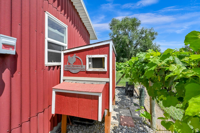 13658 South Fort Street Draper, UT 84020 - Photo 55 of 87 Red corrugated siding exterior with a white window frame, complemented by a small red outbuilding with a white trim