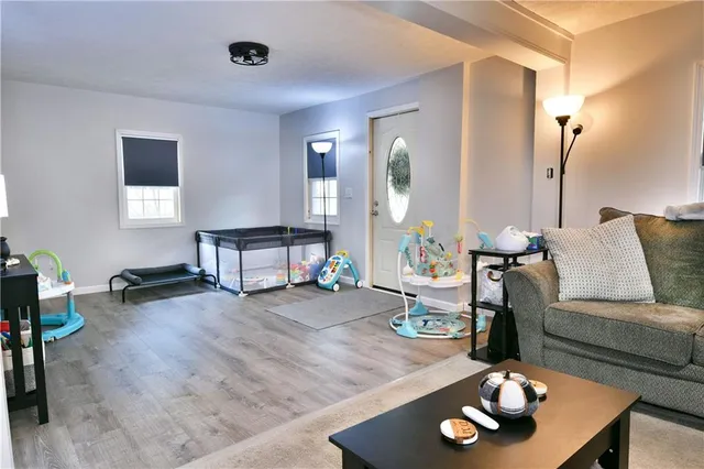 a living room with furniture and wooden floor