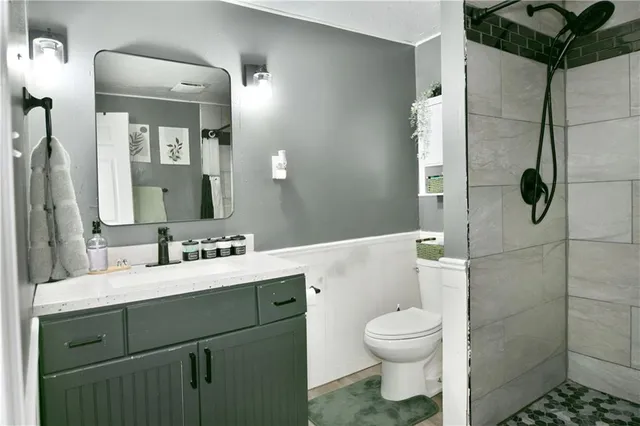 a bathroom with a toilet sink and shower
