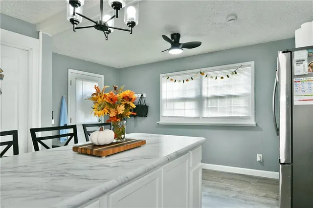 a view of dining room with kitchen furniture and wooden floor