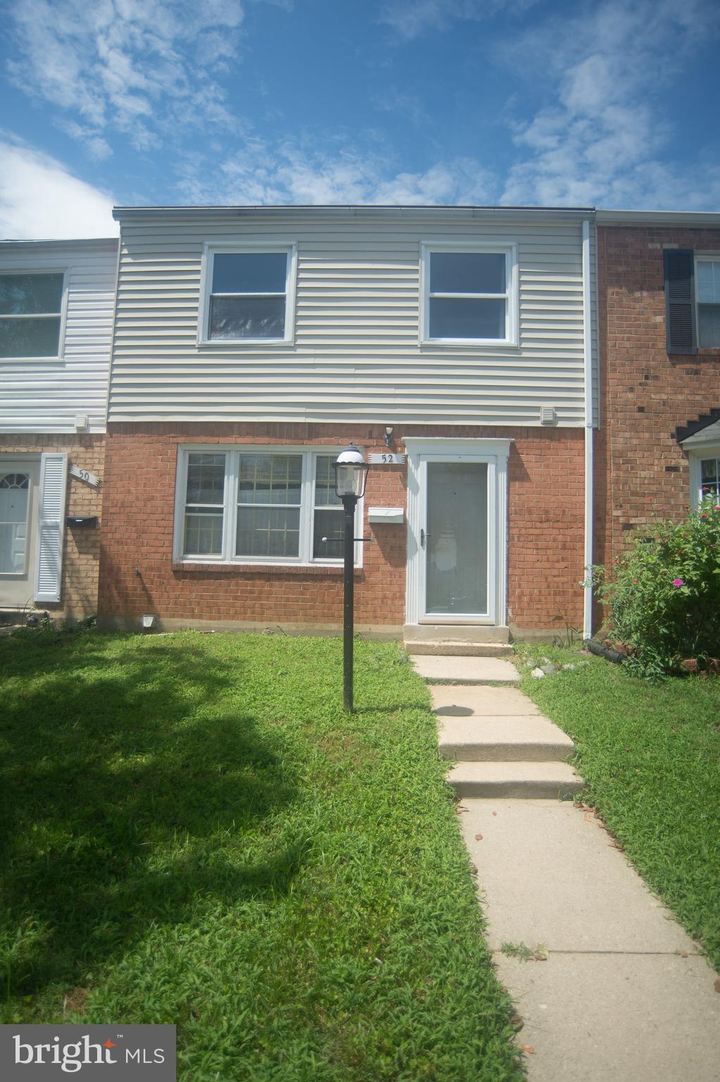 52 Timber Rock Road Gaithersburg, MD 20878 - Photo 1 of 30 a front view of a house with a garden and yard