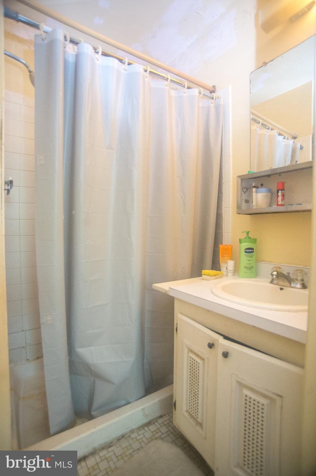 52 Timber Rock Road Gaithersburg, MD 20878 - Photo 14 of 30 a bathroom with a sink a toilet and a shower