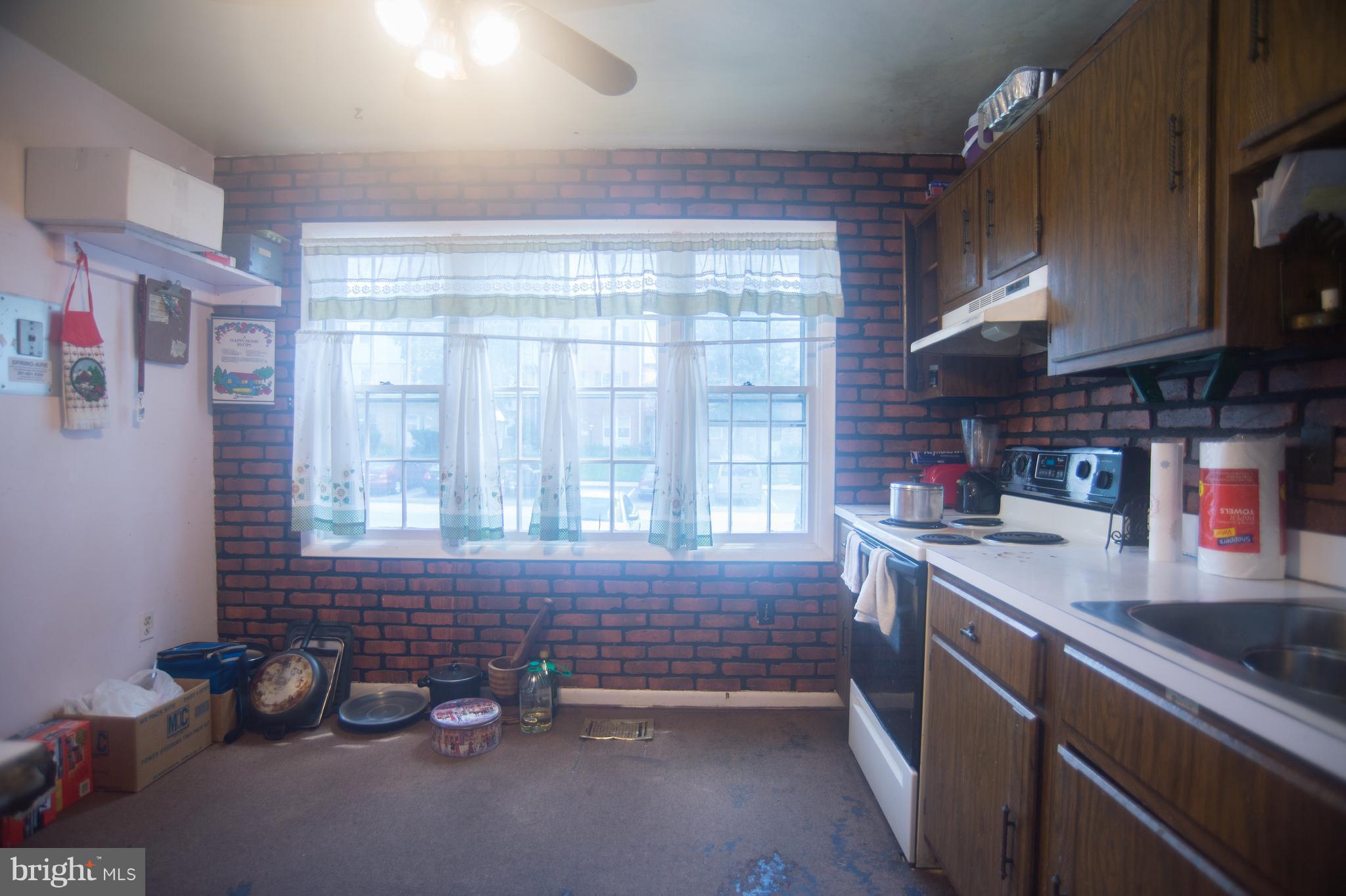 52 Timber Rock Road Gaithersburg, MD 20878 - Photo 4 of 30 a kitchen with a sink and a window