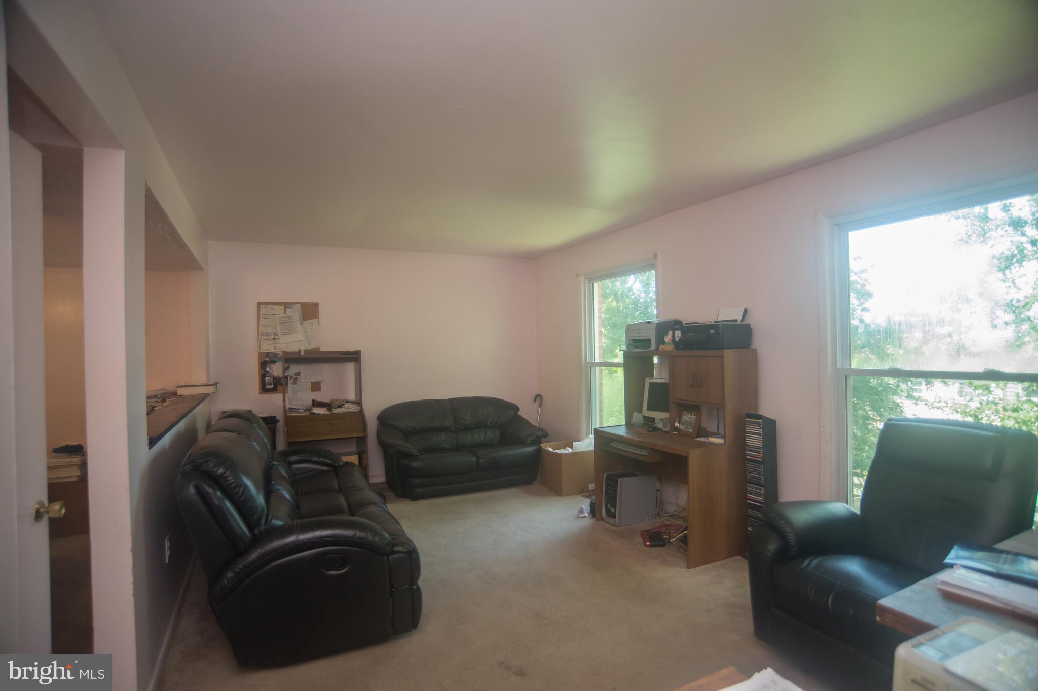 52 Timber Rock Road Gaithersburg, MD 20878 - Photo 8 of 30 a room with furniture a large window and a mirror