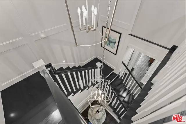 a view of staircase with white walls and a window
