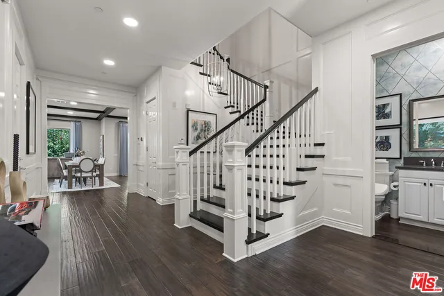a view of entryway and hall with wooden floor