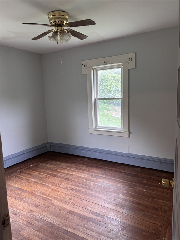 349 Oak Street Clinton, MA 01510 - Photo 5 of 9 wooden floor in an empty room with a window