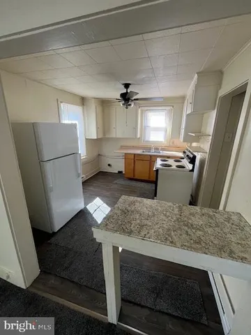 a kitchen with refrigerator and window