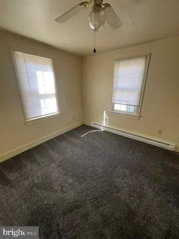 an empty room with a empty space and windows