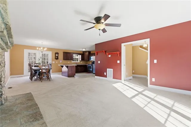 a view of a dining room with furniture and chandelier