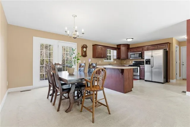 a view of a dining room with furniture and chandelier