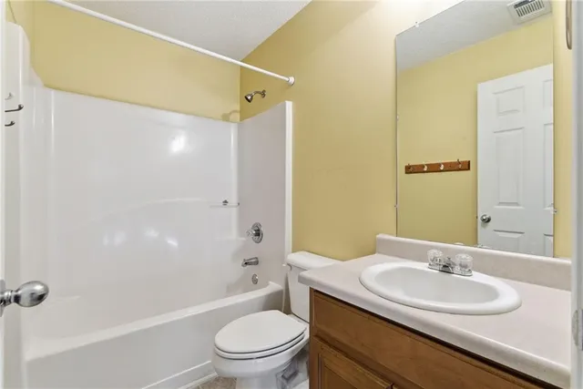 a bathroom with a sink toilet and a mirror