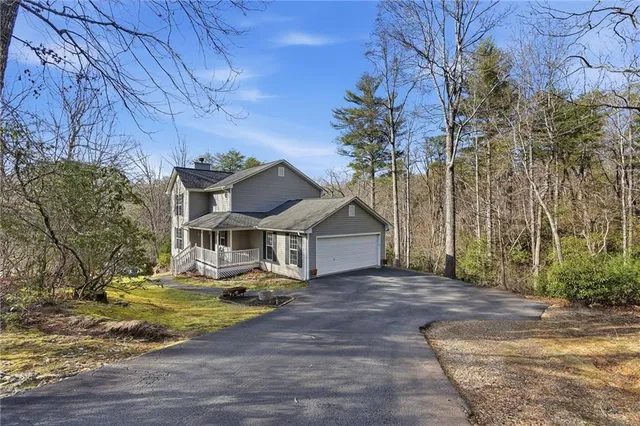 front view of a house with a yard and trees