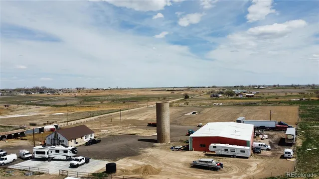 a view of a terrace with lawn chairs