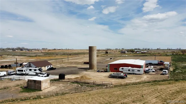 a view of a terrace with lawn chairs and ocean view