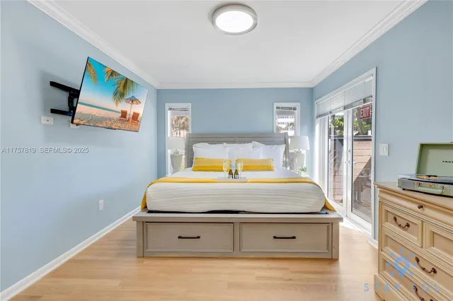 a bedroom with a bed and flat screen tv