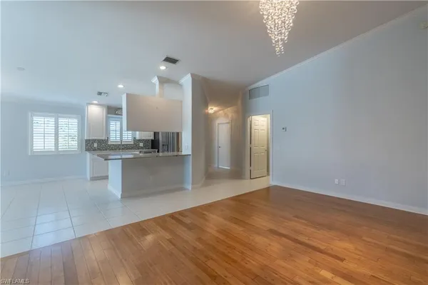 a view of kitchen and hall with wooden floor