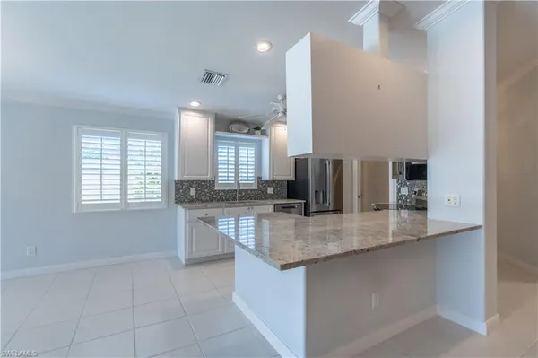 a kitchen with stainless steel appliances granite countertop a sink and a granite counter tops