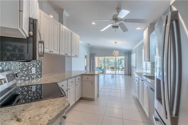 a large kitchen with stainless steel appliances granite countertop a stove a sink dishwasher and a refrigerator