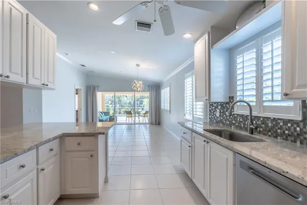 a large white kitchen with a large window