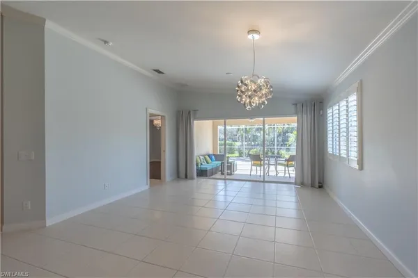 a view of a room with windows and chandelier