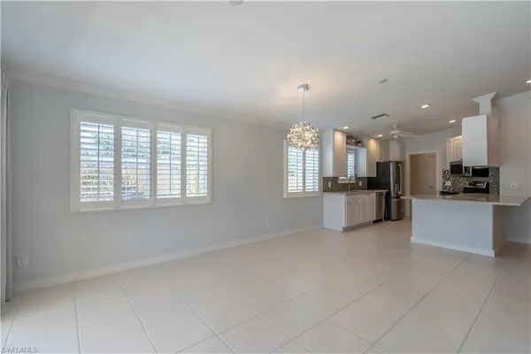 a view of kitchen with refrigerator and window