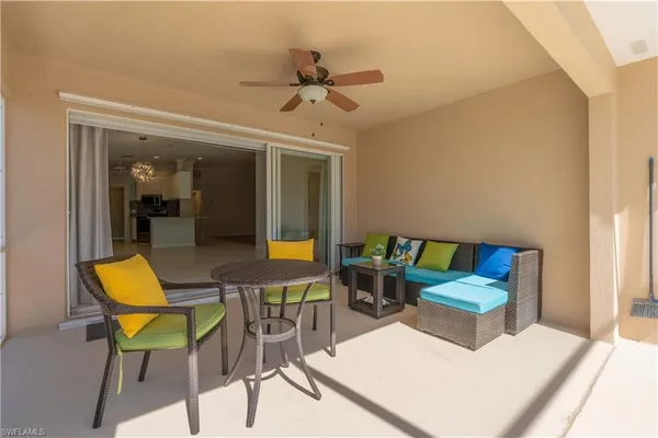 a view of a house with a yard and potted plants