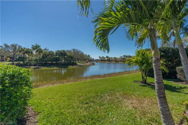 a view of a lake with houses in the back
