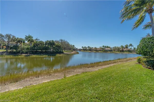 a view of a lake with houses in the back