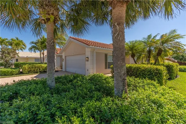 a front view of house with a garden
