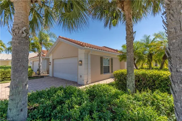 a view of a house with a tree in the yard
