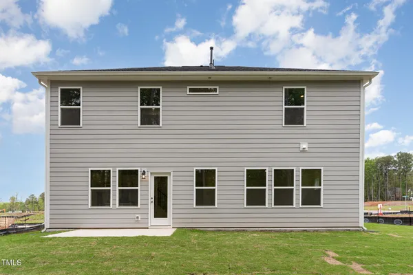 a back view of a house with a yard