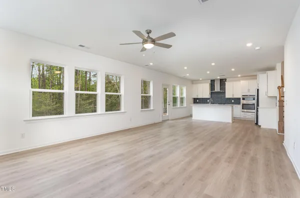 a view of large kitchen with a sink and microwave