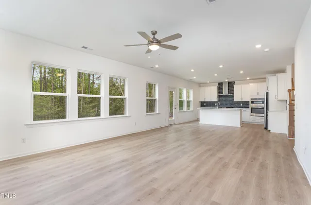 a view of large kitchen with a sink and microwave