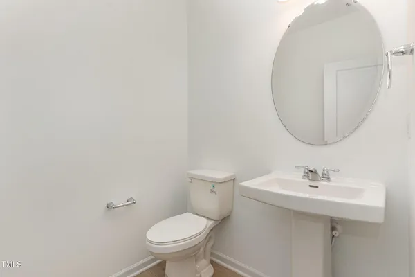 a bathroom with a sink toilet and a mirror