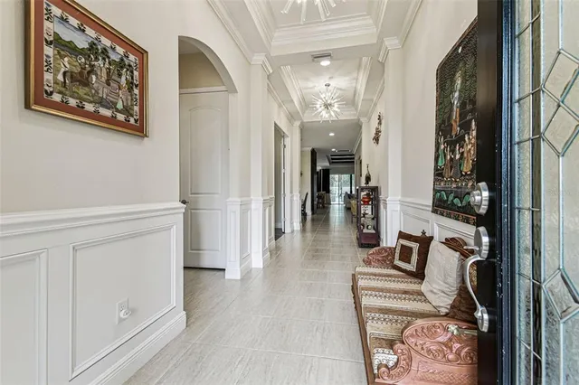 a kitchen with stainless steel appliances kitchen island granite countertop a refrigerator a stove a sink a dining table and chairs with wooden floor