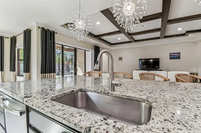 a bedroom with a bed a large window and wooden floor