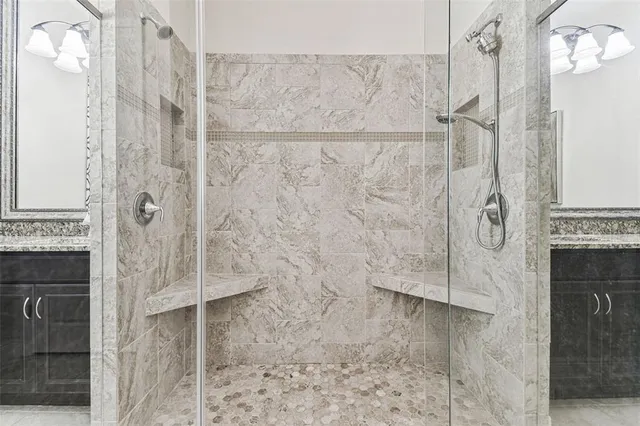 a bathroom with a sink a mirror and shower