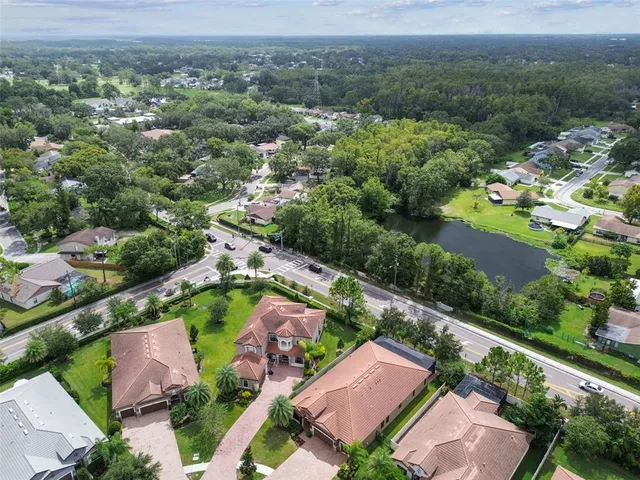 an aerial view of a city with lots of residential buildings and mountain view in back