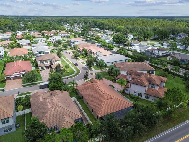 an aerial view of residential houses with outdoor space and street view