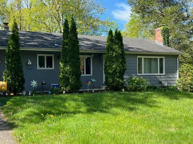 a front view of house with yard and green space