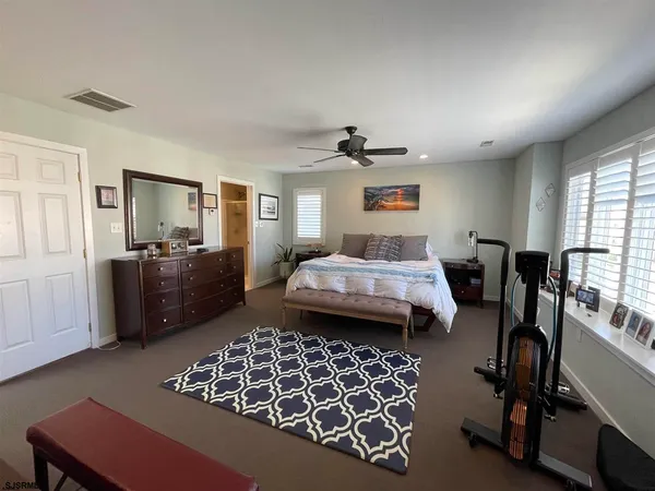 a bedroom with furniture and a window