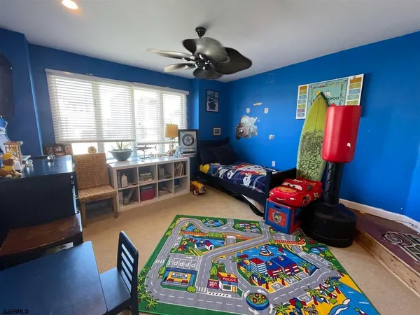 a very nice looking bedroom with furniture and a chandelier