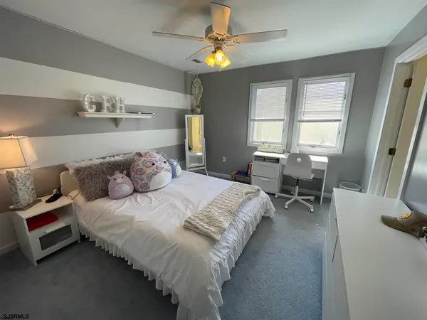 a bedroom with bed and a window