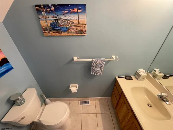 a bathroom with a sink mirror vanity and toilet