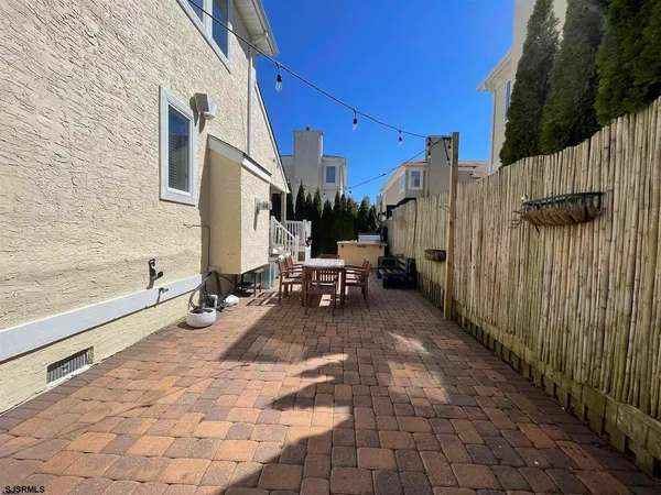 a view of a patio with chairs and potted plants