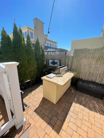 a view of a patio with table and chairs with wooden floor and fence